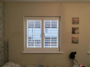 White Window Shutters In Child's Bedroom