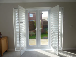 Open White Louvered Shutters Across French Doors