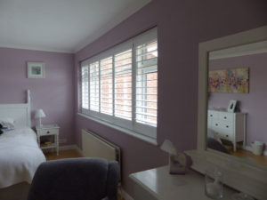 White Louvered Shutters On Wide Bedroom Window