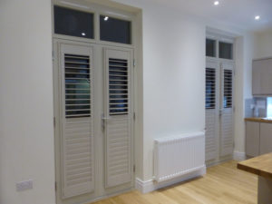 Light Grey Shutters Attached To Inward Opening Doors