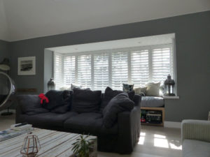 Lounge Square Bay Window With White Plantation Shutters