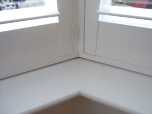 Close Up Showing Corner Join Of White Shutters In Angled Bay Window