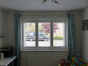 White Plantation Shutters With TPosts In Child's Bedroom